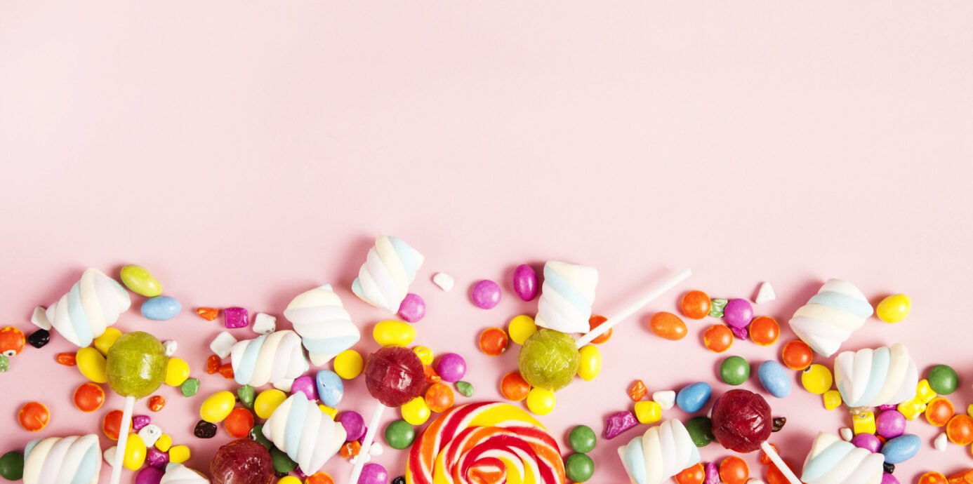 colorful candy on pink background